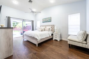 Vaulted Primary Bedroom with pool views and patio door to pool area.