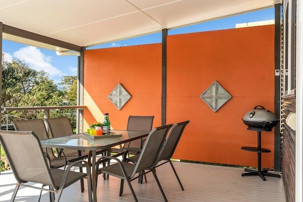 Covered rear entertaining deck with ocean views and the sounds of crashing waves.