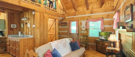 Cozy living room area with locally carved scene on the loft railing. Artist from Wears Valley Road.