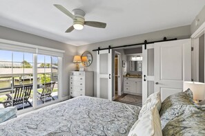 Master bedroom with an ensuite, scenic views of the canal, and direct access to the patio.