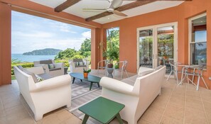Large terrace with garden and ocean view.