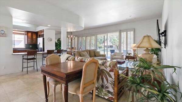 Great room with sliding doors to patio, greenbelt and community pool