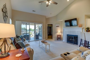 Living room with plenty for seating, TV & deck access.