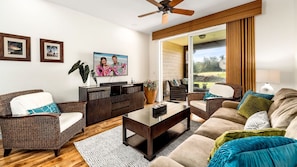 The living area of this Halii Kai condo with couch and armchair.