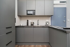 Modern, functional kitchenette interior with high-quality appliances that provide the ability to prepare home-cooked meals.