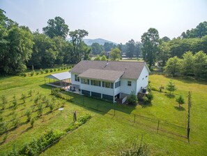 Welcome to Blueberry Grove—a private wooded retreat with flat parking and a charming covered porch.