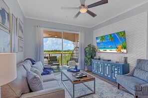 Sunny living room with big 75" smart TV.