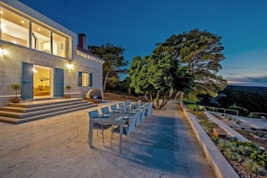 Exterior of a private holiday villa Brač in an evening setting with a view of the sea 