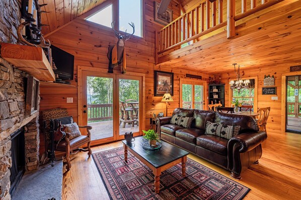 Living room with wood burning fireplace and access to the deck