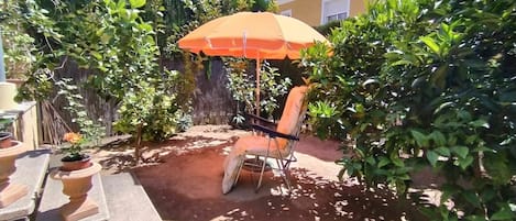 Plant, Property, Sky, Plant Community, Building, Shade, Outdoor Furniture, House, Umbrella, Tree