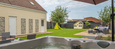 Grace Cottage, Heacham: Hot tub looking down the garden to outside dining areas beyond