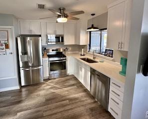 Newly updated kitchen! Gas stove and quartz countertops.