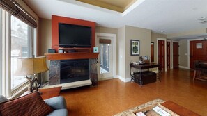 Living room with fireplace and TV