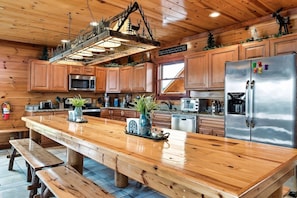14-Person dining table with custom-made cozy lighting. Large, home-cooked meals...YES, please!!
