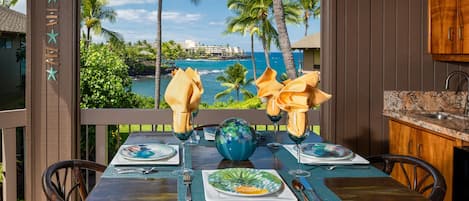 Enjoy Kona coffee and island fruit while feeling the ocean breezes