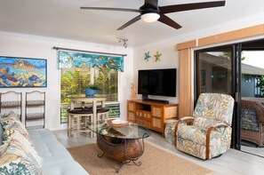 Left side of living room with handcrafted stained glass valance over the large window.