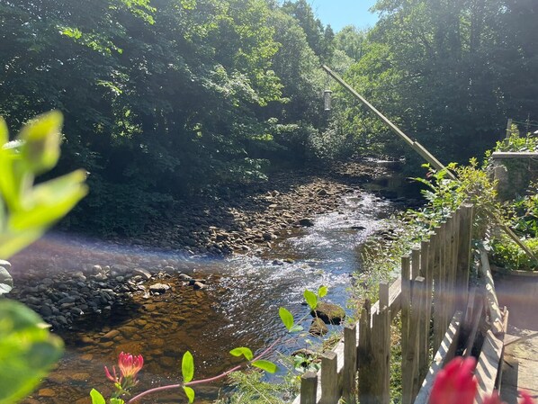 The Roeburn flows alongside the garden of the Riverside Tailor’s Cottage