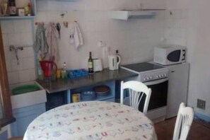 The kitchen and dining area of the ground floor room.
