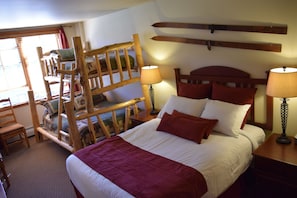 Master bedroom sleeps five with custom built beetle kill bunk bed.