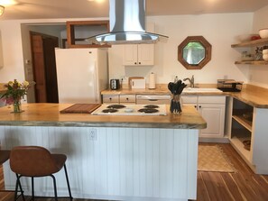 Looking at the kitchen from the open concept dining room/living room 