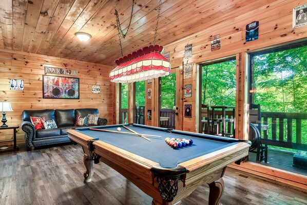 Music-themed lower level with sleeper sofa, pool table, Roku TV, & music player
