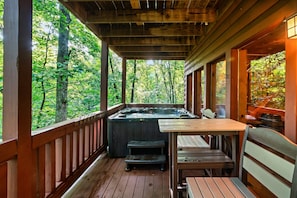 Hot tub, polywood chairs, and tables on the lower level deck

