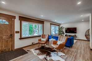 Main floor entry/living room with 65" Roku smart TV with antenna and Netflix.