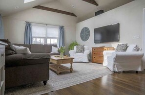 living room with beamed ceilings and fireplace