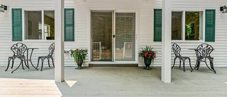 Front entrance with deck and sliding glass door.