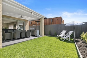 The secure garden provides a safe space for kids to play on the lawn while adults relax in the alfresco area.