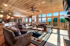 Wall of windows facing Mt LeConte, gas fireplace, 55" Smart 4K TV, ample seating. Bluetooth speaker for music.