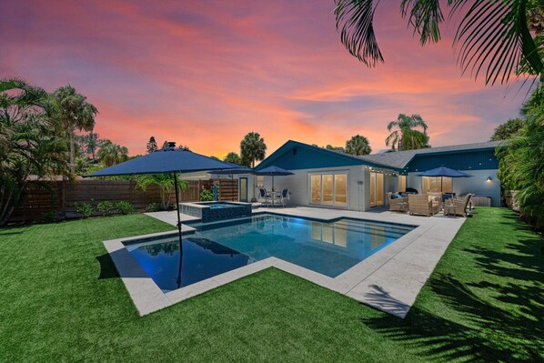 One Day More view of the pool at dusk