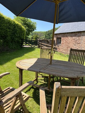 Cottage garden with table, chairs and BBQ