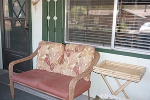 Additional seating on the screened in porch.