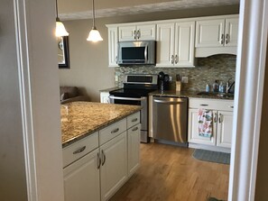 All stainless steel appliances in the open concept kitchen