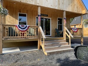 Front porch with Adirondack chairs to relax with access to restaurants and shops