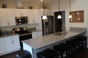 The deluxe kitchen includes all new stainless steel appliances.