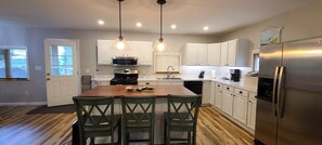 Large Fully stocked kitchen with Island Seating available.