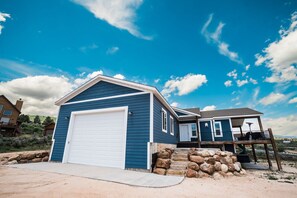 Large garage, pull-through driveway and additional parking to the West