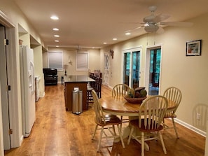 View from dining area into kitchen and living room.