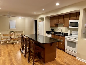 Dining room and kitchen with bar. This also opens up to the living room area.