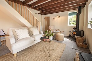 Ground floor:  Spacious sitting room with comfortable seating flanking the wood burning stove