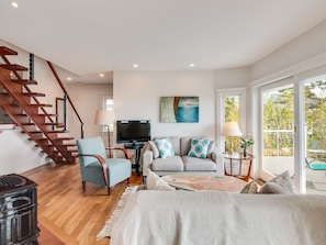 Living room with open mahogany staircase, TV