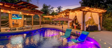 Amazing colorful LED lit pool with multi changing colors and large pergolas. 