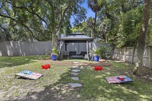 New backyard gazebo with fire pit and games!