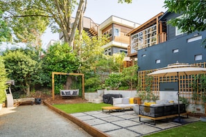 Access to backyard (bocce ball court, seating, swing, fountain, hammock) 
