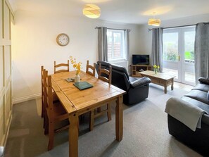 Relaxing living room with views out of the French doors across Dartmoor | Dartmoor View - Newbarn Farm, Collaton St Mary, near Paignton
