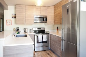 Our modern kitchen is fully stocked for all your culinary needs.