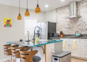 This kitchen was designed with you in mind. The custom walnut river table island is a complete show-stopper!