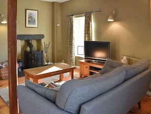 Living room with wood burner | Letterbox Cottage, near Hawkshead